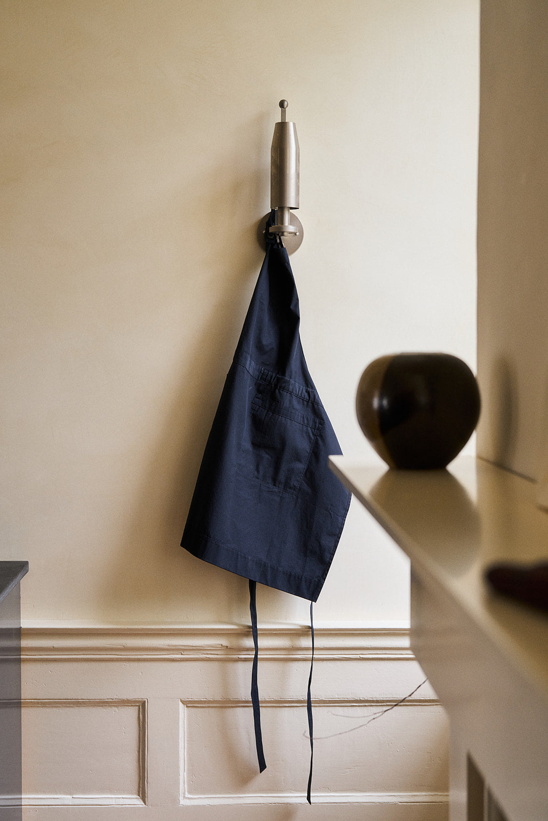 a blue apron hanging on the wall